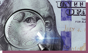 100 US Dollar under magnifying glass. close-up